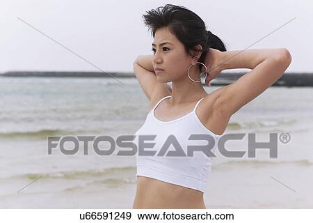 Stock Photo - Beach, Exercising, Yoga, Body Care, Body Conscious, Fitness, Asian Ethnicity. Fotosearch