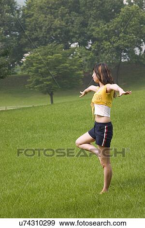 Stock Photo - Beach, Exercising, Yoga, Body Care, Body Conscious, Fitness, Asian Ethnicity. Fotosearch