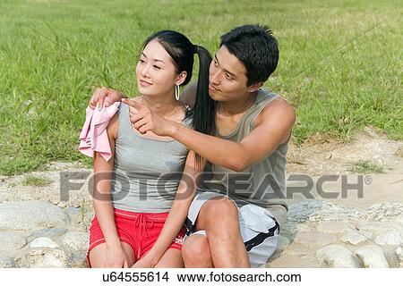 Picture - Greenery, Young Couple, Lying Down, Leisure Activity, Young Adult, Asian Ethnicity. Fotosearch