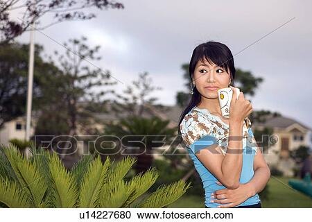 Stock Image - Greenery, Young Couple, Lying Down, Leisure Activity, Young Adult, Asian Ethnicity. Fotosearch