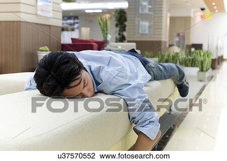 Stock Image - Greenery, Young Couple, Lying Down, Leisure Activity, Young Adult, Asian Ethnicity. Fotosearch