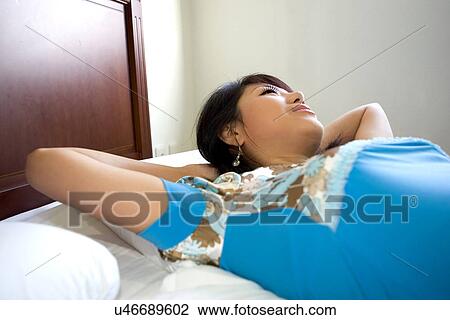 Greenery, Young Couple, Lying Down, Leisure Activity, Young Adult, Asian Ethnicity View Large Photo Image Stock Image - Greenery, Young Couple, Lying Down, Leisure Activity, Young Adult, Asian Ethnicity. Fotosearch