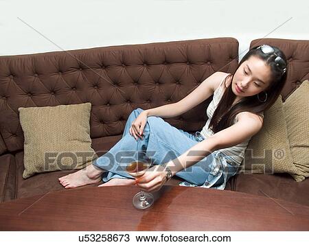Stock Image - Greenery, Young Couple, Lying Down, Leisure Activity, Young Adult, Asian Ethnicity. Fotosearch