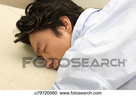 Stock Image - Greenery, Young Couple, Lying Down, Leisure Activity, Young Adult, Asian Ethnicity. Fotosearch