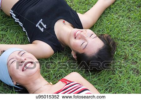 Greenery, Young Couple, Lying Down, Leisure Activity, Young Adult, Asian Ethnicity View Large Photo Image Stock Image - Greenery, Young Couple, Lying Down, Leisure Activity, Young Adult, Asian Ethnicity. Fotosearch