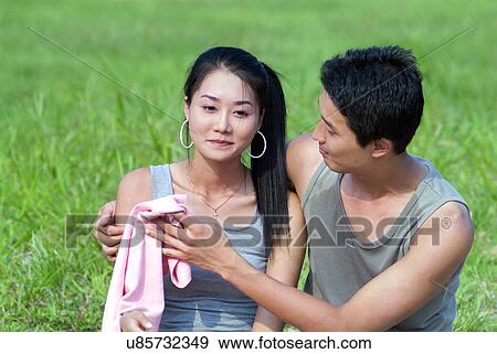 Greenery, Young Couple, Lying Down, Leisure Activity, Young Adult, Asian Ethnicity View Large Photo Image Stock Photo - Greenery, Young Couple, Lying Down, Leisure Activity, Young Adult, Asian Ethnicity. Fotosearch