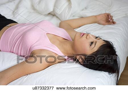 Greenery, Young Couple, Lying Down, Leisure Activity, Young Adult, Asian Ethnicity View Large Photo Image Stock Photo - Greenery, Young Couple, Lying Down, Leisure Activity, Young Adult, Asian Ethnicity. Fotosearch
