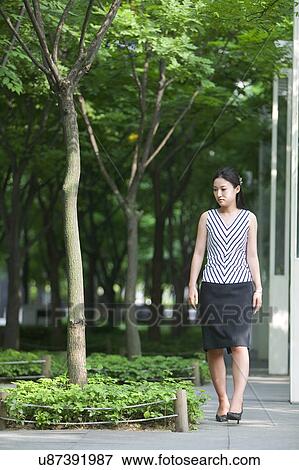 Stock Photo - Greenery, Young Couple, Lying Down, Leisure Activity, Young Adult, Asian Ethnicity. Fotosearch
