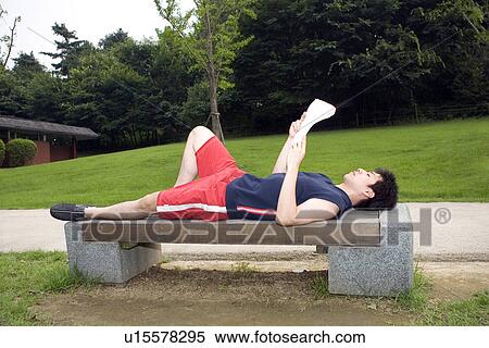 Stock Photography - Greenery, Young Couple, Lying Down, Leisure Activity, Young Adult, Asian Ethnicity. Fotosearch