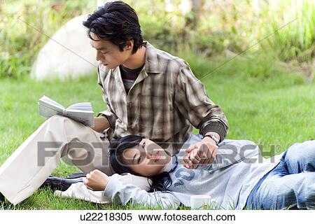 Greenery, Young Couple, Lying Down, Leisure Activity, Young Adult, Asian Ethnicity View Large Photo Image Stock Photography - Greenery, Young Couple, Lying Down, Leisure Activity, Young Adult, Asian Ethnicity. Fotosearch