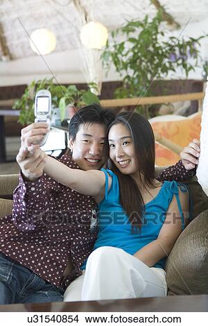 Picture - Indoors, Young Adult, Young Men, Young Women, Young Couple, Togetherness, Bonding. Fotosearch