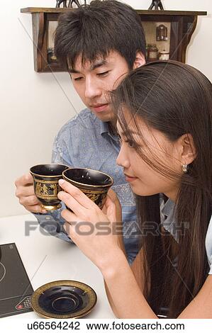Indoors, Young Adult, Young Men, Young Women, Young Couple, Togetherness, Bonding View Large Photo Image Stock Image - Indoors, Young Adult, Young Men, Young Women, Young Couple, Togetherness, Bonding. Fotosearch