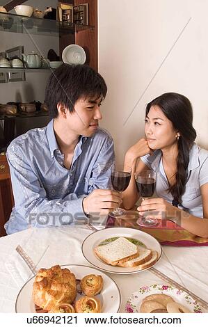 Stock Image - Indoors, Young Adult, Young Men, Young Women, Young Couple, Togetherness, Bonding. Fotosearch