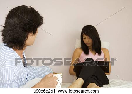 Stock Image - Indoors, Young Adult, Young Men, Young Women, Young Couple, Togetherness, Bonding. Fotosearch
