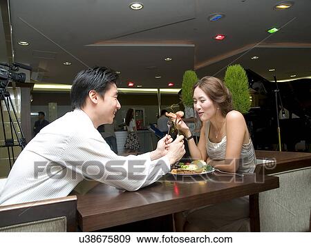 Indoors, Young Adult, Young Men, Young Women, Young Couple, Togetherness View Large Photo Image Stock Photo - Indoors, Young Adult, Young Men, Young Women, Young Couple, Togetherness. Fotosearch