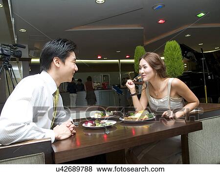 Stock Photo - Indoors, Young Adult, Young Men, Young Women, Young Couple, Togetherness. Fotosearch