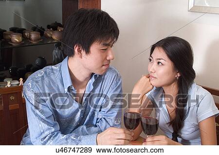Stock Photo - Indoors, Young Adult, Young Men, Young Women, Young Couple, Togetherness, Bonding. Fotosearch