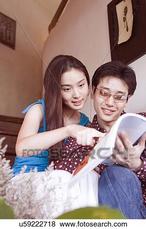 Indoors, Young Adult, Young Men, Young Women, Young Couple, Togetherness, Bonding View Large Photo Image Stock Photo - Indoors, Young Adult, Young Men, Young Women, Young Couple, Togetherness, Bonding. Fotosearch