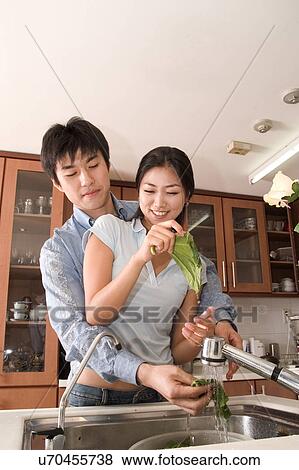 Stock Photo - Indoors, Young Adult, Young Men, Young Women, Young Couple, Togetherness, Bonding. Fotosearch
