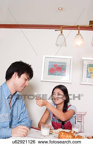 Stock Photograph - Indoors, Young Adult, Young Men, Young Women, Young Couple, Togetherness, Bonding. Fotosearch