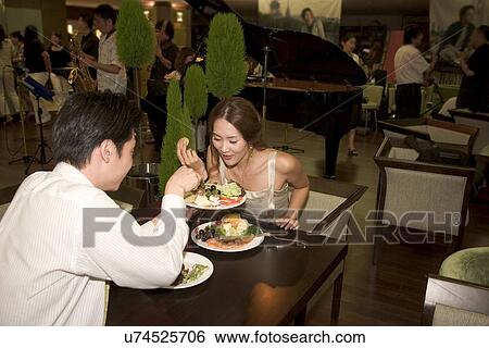 Stock Photograph - Indoors, Young Adult, Young Men, Young Women, Young Couple, Togetherness. Fotosearch