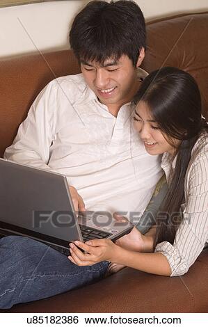 Indoors, Young Adult, Young Men, Young Women, Young Couple, Togetherness, Bonding View Large Photo Image Stock Photograph - Indoors, Young Adult, Young Men, Young Women, Young Couple, Togetherness, Bonding. Fotosearch