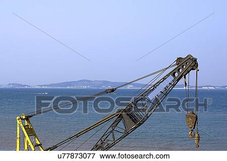 Stock Photo - Outdoors, Day, Dusk, Engineering, Industrial, Crane, Sky. Fotosearch