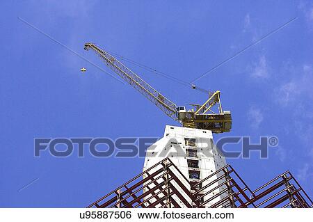 Stock Photograph - Outdoors, Day, Dusk, Engineering, Industrial, Crane, Sky. Fotosearch
