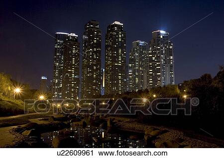 Stock Image - Outdoors, Urban Scene, Building Structure, Building Exterior, Skyscraper, Light, Illuminated. Fotosearch