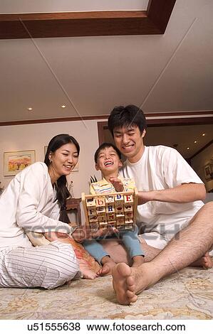 Stock Photo - Togetherness, Mother, Love, Father, Daughter, Asian Ethnicity. Fotosearch
