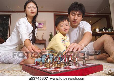 Stock Photo - Togetherness, Mother, Love, Father, Daughter, Asian Ethnicity. Fotosearch