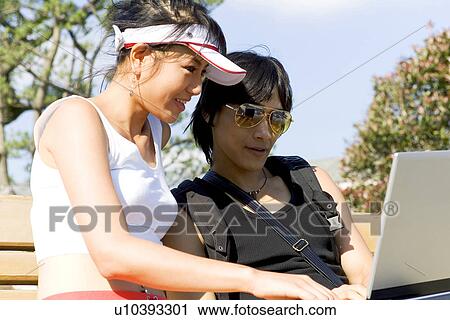 Stock Image - Wireless Technology, Mobile Phone, Laptop, Connected, New Age, Happiness, Youth. Fotosearch
