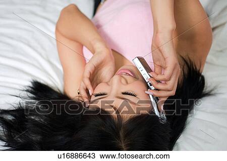 Stock Image - Wireless Technology, Mobile Phone, Laptop, Connected, New Age, Happiness, Youth. Fotosearch