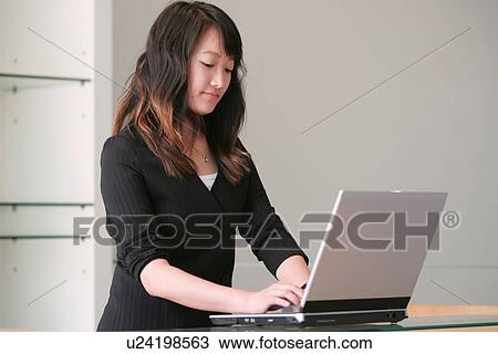 Stock Image - Wireless Technology, Mobile Phone, Laptop, Connected, New Age, Happiness, Youth. Fotosearch