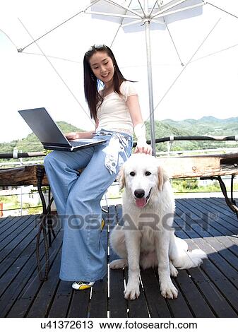 Stock Image - Wireless Technology, Mobile Phone, Laptop, Connected, New Age, Happiness, Youth. Fotosearch