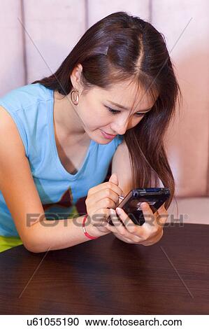 Stock Image - Wireless Technology, Mobile Phone, Laptop, Connected, New Age, Happiness, Youth. Fotosearch