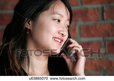 Stock Image - Wireless Technology, Mobile Phone, Laptop, Connected, New Age, Happiness, Youth. Fotosearch