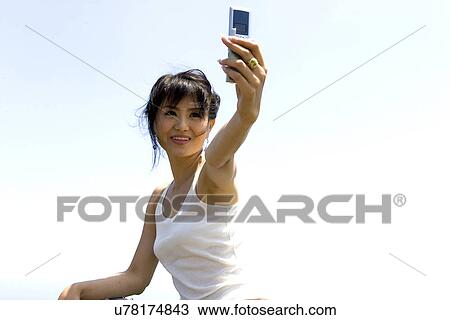 Stock Image - Wireless Technology, Mobile Phone, Laptop, Connected, New Age, Happiness, Youth. Fotosearch