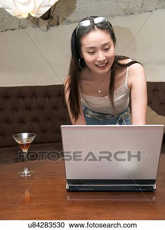 Stock Image - Wireless Technology, Mobile Phone, Laptop, Connected, New Age, Happiness, Youth. Fotosearch