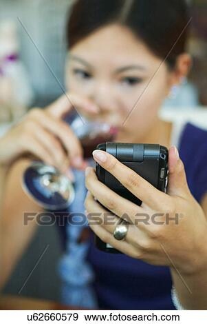 Stock Photo - Wireless Technology, Mobile Phone, Laptop, Connected, New Age, Happiness, Youth. Fotosearch