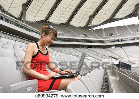 Stock Photo - Wireless Technology, Mobile Phone, Laptop, Connected, New Age, Happiness, Youth. Fotosearch