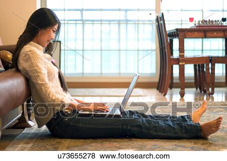 Stock Photo - Wireless Technology, Mobile Phone, Laptop, Connected, New Age, Happiness, Youth. Fotosearch