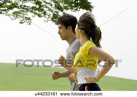 Stock Image - Young Adult, Young Men, Young Women, Outdoors, Sports Clothing, Athletic, Healthy Lifestyle. Fotosearch