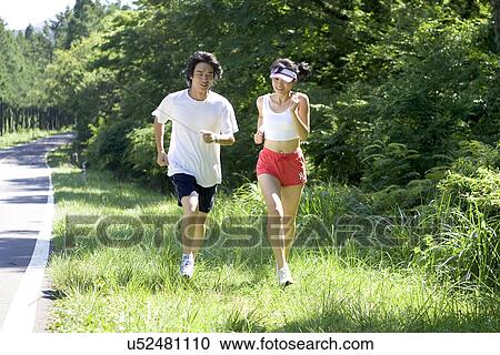 Stock Image - Young Adult, Young Men, Young Women, Outdoors, Sports Clothing, Athletic, Healthy Lifestyle. Fotosearch