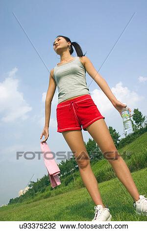 Stock Image - Young Adult, Young Men, Young Women, Outdoors, Sports Clothing, Athletic, Healthy Lifestyle. Fotosearch