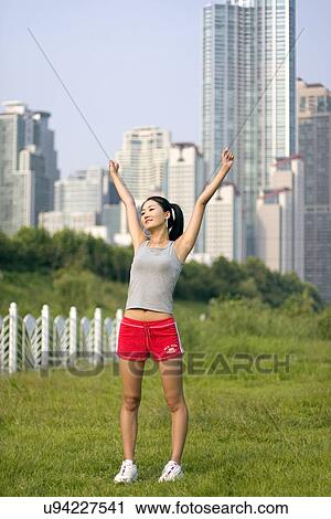 Stock Image - Young Adult, Young Men, Young Women, Outdoors, Sports Clothing, Athletic, Healthy Lifestyle. Fotosearch