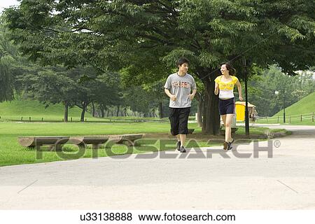 Young Adult, Young Men, Young Women, Outdoors, Sports Clothing, Athletic, Healthy Lifestyle View Large Photo Image Stock Photo - Young Adult, Young Men, Young Women, Outdoors, Sports Clothing, Athletic, Healthy Lifestyle. Fotosearch