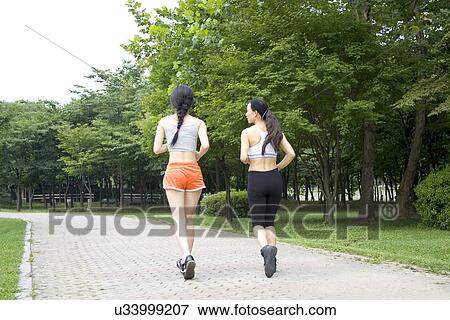 Stock Photo - Young Adult, Young Men, Young Women, Outdoors, Sports Clothing, Athletic, Healthy Lifestyle. Fotosearch