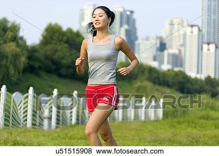 Stock Photo - Young Adult, Young Men, Young Women, Outdoors, Sports Clothing, Athletic, Healthy Lifestyle. Fotosearch
