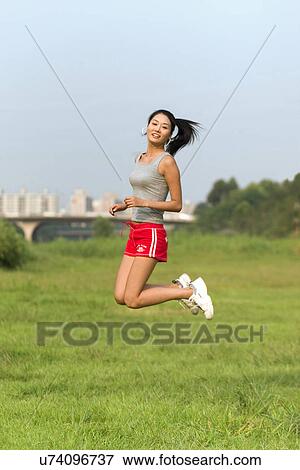 Stock Photo - Young Adult, Young Men, Young Women, Outdoors, Sports Clothing, Athletic, Healthy Lifestyle. Fotosearch